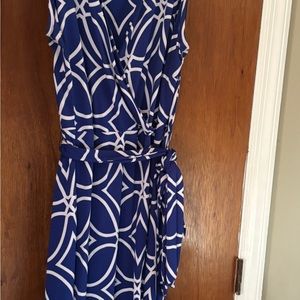 Royal blue and white pattern with black and white pattern on skirt. Faux wrap.